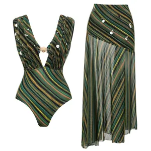 Detailed view of striped one-piece swimsuit and matching long skirt with sequins