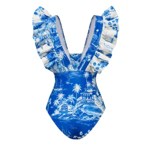 Detailed view of blue tropical island print one-piece swimsuit with ruffled straps.