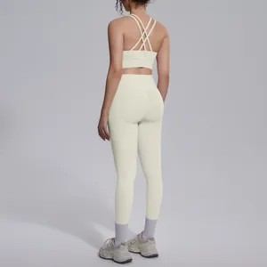 Rear view of cream-colored cross-back sports bra and high-waisted yoga leggings set