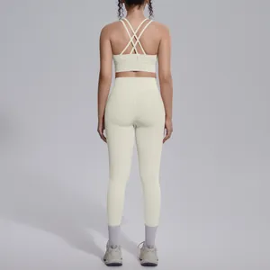 Back view detail of cream high-waist yoga set featuring cross-strap bra and leggings