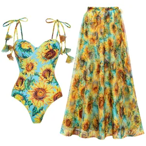 Vibrant sunflower print one-piece swimsuit set with matching sheer beach maxi skirt.