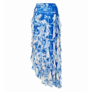 Close-up detail of blue and white island print ruffle skirt featuring a tropical landscape design