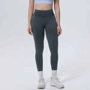Frontal view showing the fit of seamless high-waisted yoga pants in a dark grey washed fabric