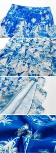 Close-up of blue tropical island print fabric with ruffled layers and texture details.