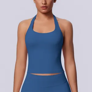 Close-up view showing the seamless texture and halter neck design of a blue yoga sports top.