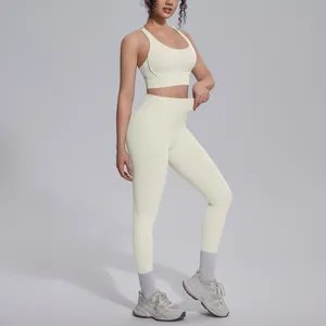Full-length side view of cream-colored high-waisted yoga leggings and matching sports bra