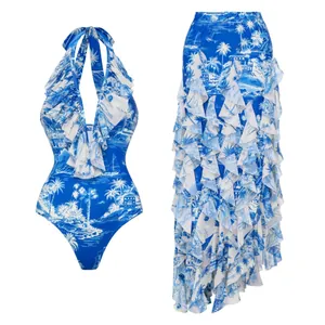Close-up of elegant blue palm tree print swimsuit set with ruffled maxi beach skirt.