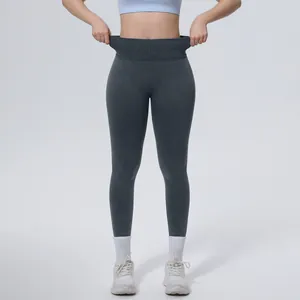 Close-up view of dark grey high-waisted seamless washed yoga leggings with tummy control effect