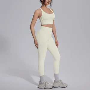 Side view detail of creamy white nylon sports bra and high-waist yoga leggings set