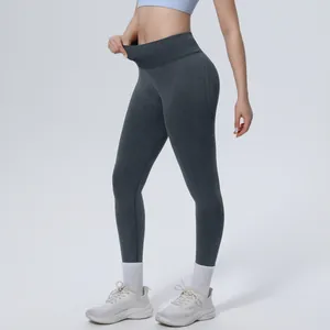 Close-up showing the high-waisted tummy control design of seamless grey yoga pants