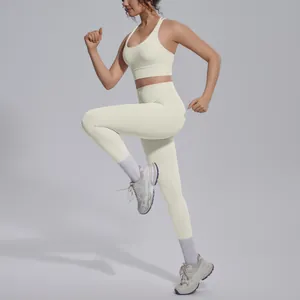 Full view detail of a cream nylon sports set featuring cross-back bra and leggings