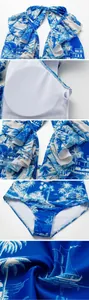 Detailed view of blue coconut tree print swimsuit with ruffled neckline and pads.