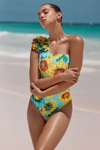 Elegant one-piece swimsuit featuring a vibrant sunflower print and 3D floral shoulder detail.