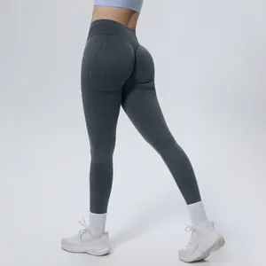 Detailed view of high-waisted seamless scrunch butt yoga leggings in dark grey.