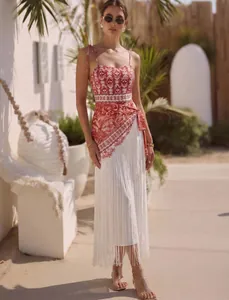 Detailed view of women's ethnic print swimwear set with long white fringe skirt