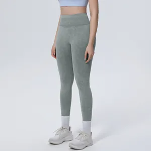 Macro view of high-waisted seamless washed yoga leggings featuring sage green stone wash