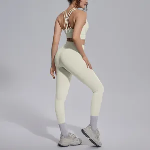Premium two-piece cream yoga set featuring cross-back sports bra and high-waisted leggings
