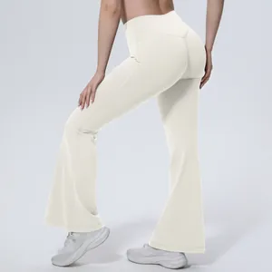 Détail du pantalon de yoga évasé blanc à taille haute montrant parfaitement l'effet galbant