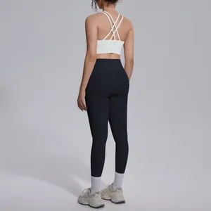 Back view of a white cross-back sports bra and black high-waisted yoga leggings set