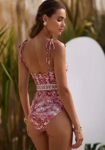 Detailed back view of a tropical print one-piece swimsuit with adjustable tie straps.