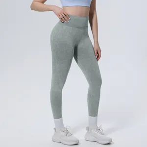 Detail view of high-waisted washed seamless yoga leggings with tummy control effect.