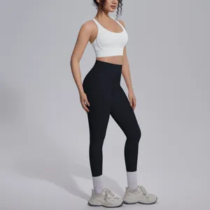 Full body side view of professional white sports bra and black high-waist yoga leggings set