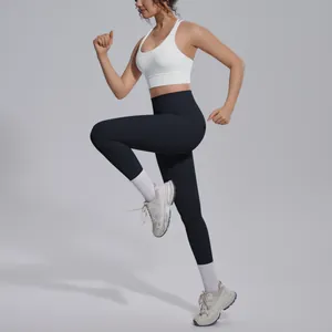 Action shot of woman in white sports bra and black yoga leggings during high knee exercise