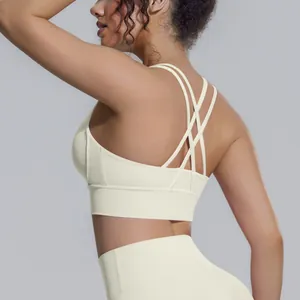 Dettaglio del design incrociato sulla schiena di un reggiseno sportivo color crema
