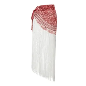 Close-up detail of ethnic patterned beach sarong with long white fringe tassels