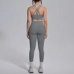 Back view of a grey yoga set featuring a cross-back sports bra and high-waisted leggings.