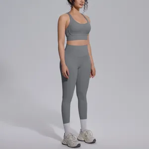 Full body view of a woman wearing a grey seamless yoga set for fitness and running