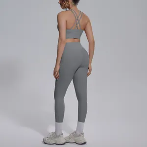 Back view of grey yoga set showing crisscross sports bra and high-waisted leggings.