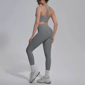 Back view of a grey seamless yoga set with a criss-cross sports bra and leggings