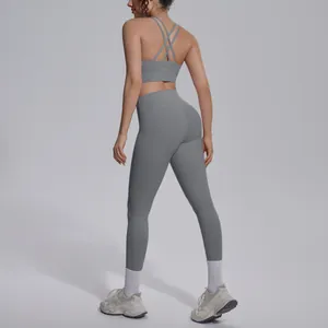 Back view of grey nylon yoga set with cross strap sports bra and high waist leggings