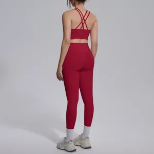 Detail view showing the rear fit of a red cross-back sports bra and yoga leggings