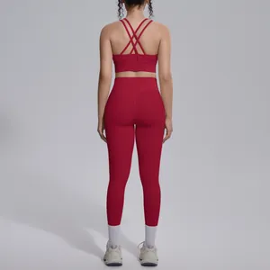 Back view of red cross-back sports bra and leggings set for yoga and fitness training