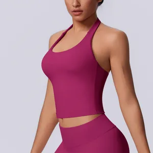 Detailed view of a professional fuchsia seamless halter neck yoga bra top on model