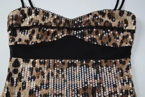 Close-up of leopard print sequin dress with black mesh waist panel and thin straps.