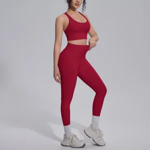Detail view of red high-waist yoga leggings showing the elasticity and naked-feel nylon fabric