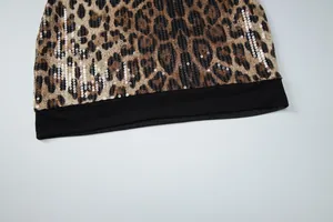 Detailed view of the leopard print fabric featuring silver sequins and black mesh hem