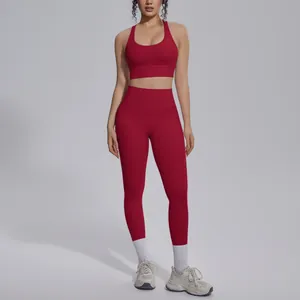 Detailed view of dark red yoga set featuring sports bra and high-waist leggings on a model.