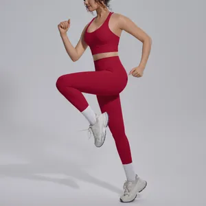 Athletic woman in a red naked-feel nylon sports bra and leggings set in a running pose