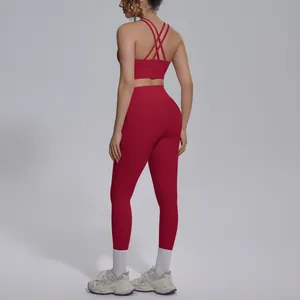 Back detail of red yoga set featuring criss-cross bra straps and high-waisted leggings
