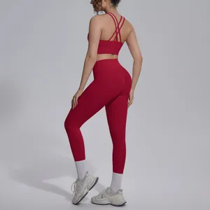 Detailed back view of red cross-back sports bra and high-waist leggings yoga set