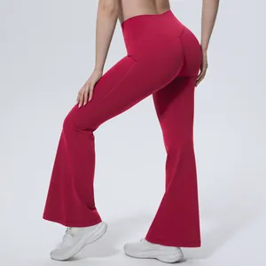 Vue détaillée du pantalon de yoga évasé rouge à taille haute montrant l'effet galbant.