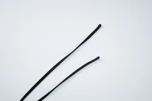 Close-up detail of the slim black shoulder straps on a sequined halter neck camisole