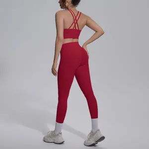Back view of a red cross-back sports bra and high-waisted yoga leggings set.