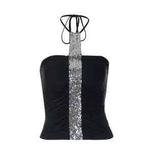 Close-up detail of silver sequin center panel and ruched texture on black halter neck top
