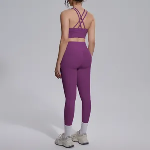 Back view of purple workout set featuring cross-strap bra and high-waist leggings
