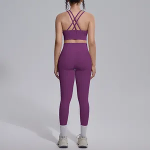 Back view of a purple yoga set with criss-cross back straps and high-waisted leggings